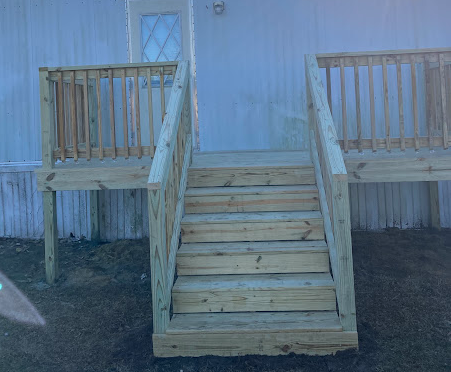 Split-level back entry deck with center stairs and side landings
